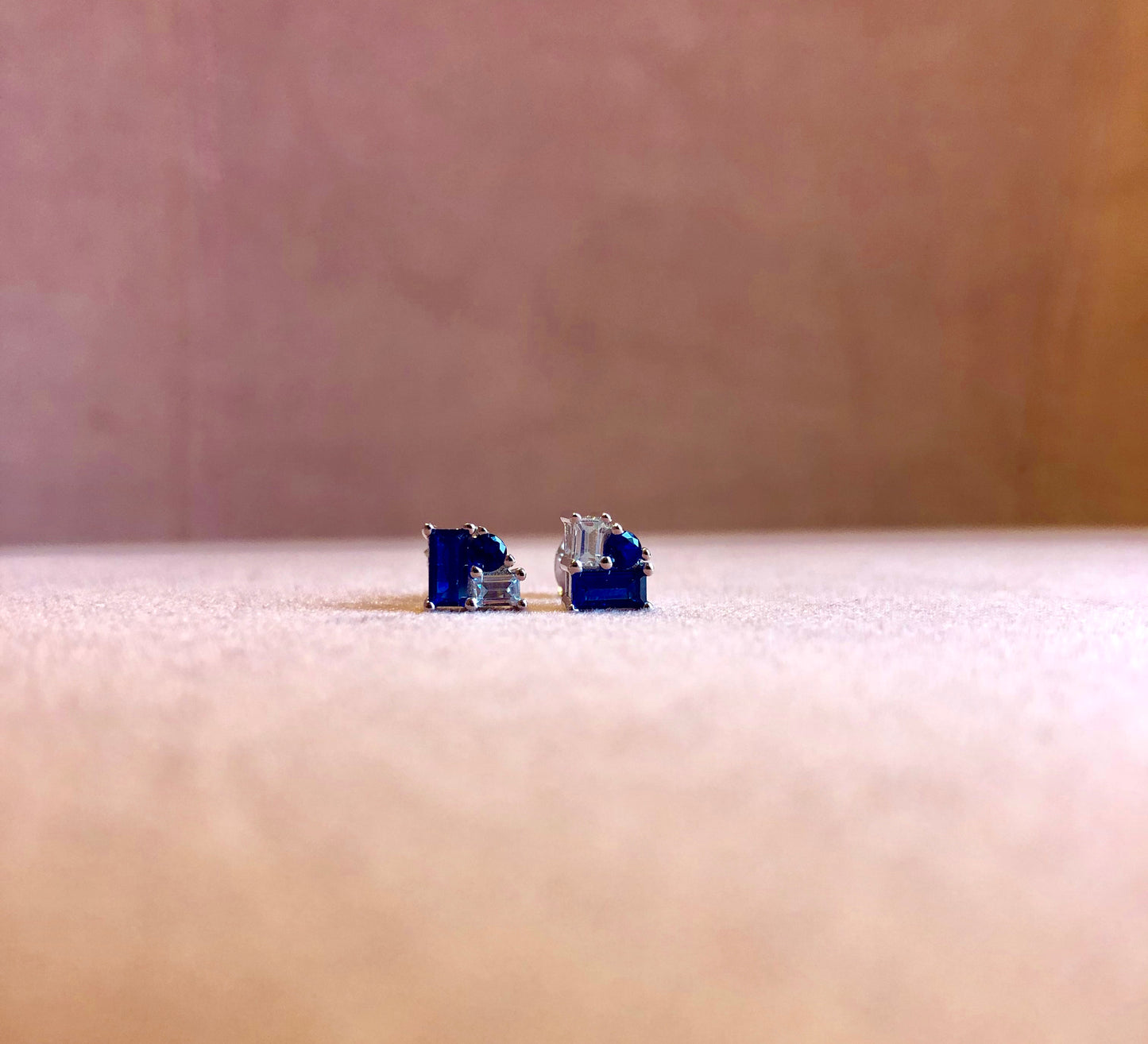 Elegantly timeless with a daring, contemporary edge, these stud Earrings are embellished with Blue and White sparkling Cubic Zirconia Crystals. Featuring a white gold-plated finishing and a post back closure.